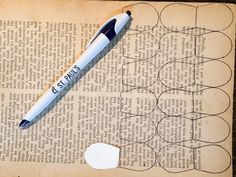 a pen sitting on top of an old book next to a hole in the paper