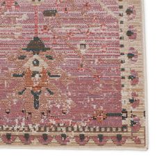 a pink rug with an intricate design on the front and back side, in various colors