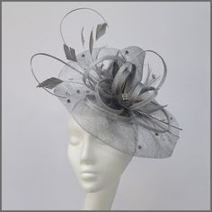 Unstructured sinamay disc in metallic silver. A versatile fascinator with sinamay loops, cut feathers, curled ostrich quills and scattered silver diamantés. Made on a headband. Please note this design is made to order, orders take approximately 2-3 weeks to be made. This design is available in other colours on request. All of our designs can be made to order in a range of different colours or styles, see our colour chart: https://jacquivaledesigns.co.uk/pages/sinamay-colour-chart Please contact Silver Fitted Fascinator For Evening, Elegant Silver Fascinator, Silver Fitted Headpieces For Formal Occasions, Elegant Fitted Silver Fascinator, Elegant Silver Wedding Fascinator, Elegant Silver Fascinator For Wedding, Silver Headpiece For Evening At Royal Ascot, Silver Fitted Fascinator For Wedding, Silver Evening Headpiece For Royal Ascot