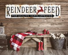 a wooden bench sitting in front of a wall with a sign that says reindeer feed