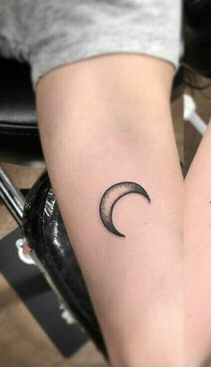 two small crescent tattoos on both legs