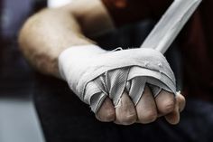 a man holding something wrapped around his wrist