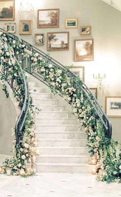 an elegant staircase decorated with flowers and greenery