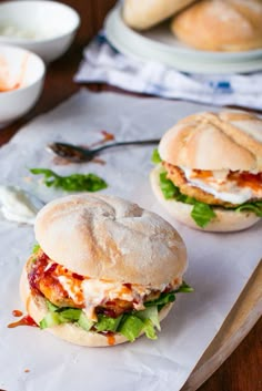 two sandwiches sitting on top of a cutting board