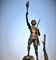 a bronze statue with a bow and arrow in his hand