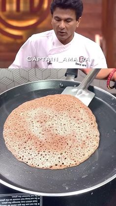 a man is cooking food in a frying pan