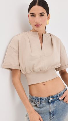 Chic Loungewear Tops With Ribbed Cuffs, Chic Tops With Ribbed Cuffs And Relaxed Fit, Chic Top With Ribbed Cuffs And Relaxed Fit, Casual Cropped Tops With Ribbed Waistband, Spring Athleisure Top With Ribbed Collar, Athleisure Tops With Ribbed Collar For Spring, Sporty Beige Top For Spring, Beige Top With Ribbed Cuffs For Spring, Spring Cropped Top With Ribbed Cuffs