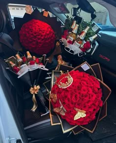 roses and other items are in the back of a car, with gold jewelry on it