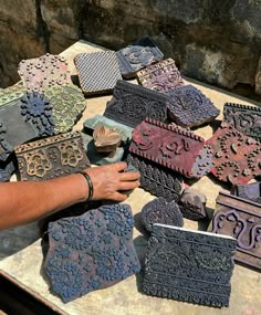 a man is working on some kind of decorative item that looks like he's making something out of clay