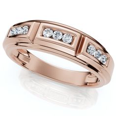 a rose gold ring with three diamonds on the side and two rows of stones in the middle