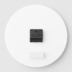 a white plate with a black object on it