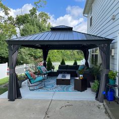 an outdoor living area with furniture and a gazebo