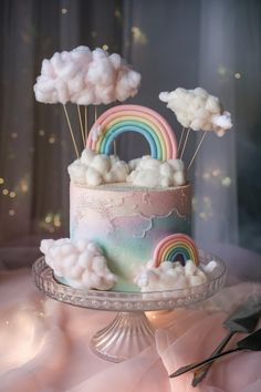 there is a cake with clouds and rainbows on it