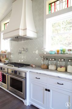 a stove top oven sitting inside of a kitchen