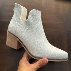 These Stylish White Vegan Leather Ankle Booties Are A Perfect Addition To Your Wardrobe. Crafted With Durable Vegan Leather, These Booties Offer A Lightweight And Comfortable Fit Without Compromising On Style. Features: Back Zipper Closure 2" Faux Wood Block Heel Vegan Leather Upper Burnished Almond Toe Faux Leather Ankle Booties With Stacked Heel, Spring White Faux Leather Booties, White Ankle Booties With Reinforced Heel, White Ankle-high Faux Leather Booties, White Faux Leather Ankle-high Booties, White Faux Leather Ankle Boots, White Faux Leather Booties With Round Toe, White Faux Leather Booties For Fall, Chic White Faux Leather Booties