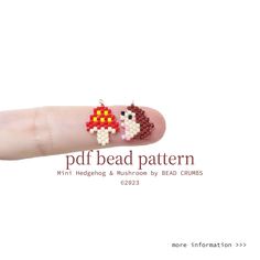 a finger with some beads on it and an image of a bird in the middle