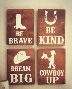 four wooden signs with the words be brave, dream, cowboy up and be kind