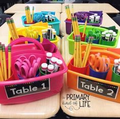 there are many different colored pencils and markers in the bins on the table