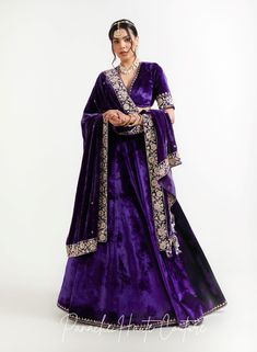 The violet color of lehenga set adds a regal touch, while the shawl can provide an additional layer of warmth and elegance. It is adorned with intricate embroidery, sequins, or other embellishments to make it stand out. When wearing a lehenga set, it's important to choose accessories that complement the outfit without overpowering it. A simple pair of earrings, a bracelet, and a clutch in a complementary color can be all that is needed to complete the look. Overall, a Violet Color Lehenga Set with a shawl from the Sensual Shadows Collection can be a stunning choice for anyone looking to make a statement with their fashion choices. The vibrant colors and intricate details are sure to turn heads and make the wearer feel like royalty. Brand: Panache Haute Couture Collection Name: The Sensual Elegant Purple Anarkali Set With Zari Work, Velvet Lehenga With Mirror Work And Traditional Drape, Festive Velvet Lehenga With Sheer Dupatta, Elegant Purple Salwar Kameez With Traditional Drape, Elegant Purple Anarkali Set For Festive Occasions, Bollywood Velvet Lehenga With Mirror Work, Elegant Velvet Lehenga With Sheer Dupatta, Velvet Choli With Dupatta For Diwali, Elegant Purple Lehenga With Dupatta