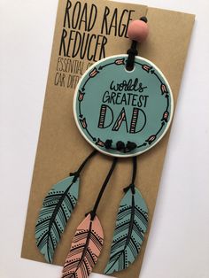 a card with an image of a blue and pink dream catcher hanging from it's side