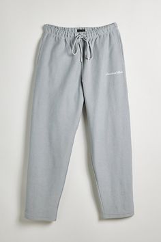 Classic sweatpants by Standard Cloth in a brushed cotton construction. Relaxed silhouette fitted with pockets and topped with logo text. Stretch elastic waistband with an adjustable tie closure. Urban Outfitters exclusive. Features Essential sweatpants from Standard Cloth Logo text embroidery Elastic waistband & adjustable drawstring tie UO exclusive Content + Care 100% Cotton Machine wash Imported Size + Fit Model in Black is 6’2.5" and wearing size Medium Measurements taken from size Medium Ri Grey Sweatpants Men, Sweat Pants Men, Cloth Logo, Mens Bottoms, Essential Sweatpants, Text Embroidery, Logo Text, Grey Sweatpants, Ankle Cuffs