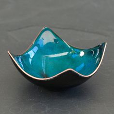 a small blue bowl sitting on top of a table