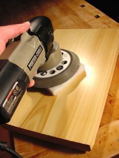 a person using a sander on a piece of wood