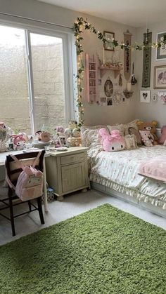 a bedroom decorated in pink and green with lots of stuffed animals