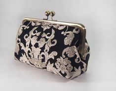 "Elegant 100% cotton black and champagne lace clutch. The inside is solid black 100% cotton (not waterproof). Handy pocket inside holds business cards, ID and credit cards. The purse is large enough to hold sunglasses, cell phones, pens, compacts...everything you need for a night out! Choose your metal purse frame finish: antique bronze, silver, rose gold or gunmetal. Contact us to have this purse made with ANY solid color fabric under the ivory lace. White lace also available upon request. We l Black Pouch Clutch For Wedding, Black Pouch Evening Bag For Wedding, Handmade Black Evening Bag For Wedding, Elegant Clutch Bag For Bridesmaid Gift, Khaki Wedding, Bridesmaid Purses, Taupe Wedding, Lace Clutch, Bridesmaid Clutch