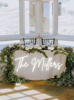 a table with flowers and greenery around it that says the millers on it