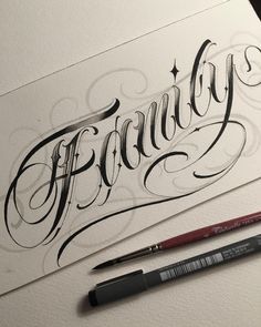 a pen and some ink sitting on top of a piece of paper with the word fantasy written in cursive writing