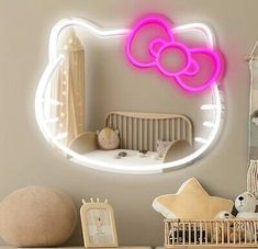 a hello kitty light up mirror on the wall above a dresser with toys in it