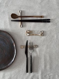 an assortment of utensils and spoons laid out on a table