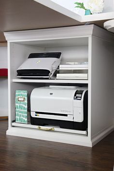 a printer sitting on top of a white shelf