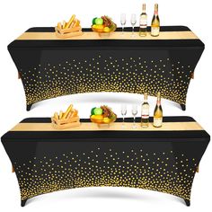 two black and gold table cloths with wine glasses, fruit and bread on them