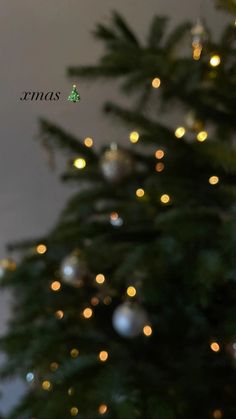 a christmas tree with lights in the background