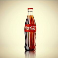 a coca cola bottle sitting on top of a table