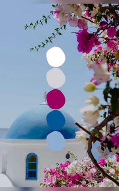 a blue dome with white and pink flowers around it