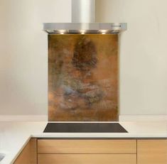 a stove top with a large metal hood over it