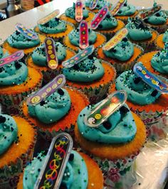 cupcakes with blue frosting and colorful decorations