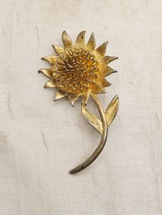 Very unique and different pin. Daisy type flower with wirework 3 dimensional center. The petals have some golden foil backing making them reflect the gold underneath. The pin itself is gold colored but very heavy plating. I have tried to find the maker and there is no marking on back.  Measures approx. 2 3/4 X 2 inch. All original and in excellent working condition. My guess this dates from 1960's - 1970's Vintage Gold Jewelry With Sunflower Design, Gold Flower Brooch Lapel Pin, Gold Flower-shaped Brooch For Gift, Gold Flower-shaped Brooches For Gifts, Gold Flower Shaped Brooch As Gift, Gold Flower Shaped Brooch For Gift, Vintage Gold Flower Shaped Brooch, Vintage Gold Flower Brooch, Vintage Gold Flower Brooches