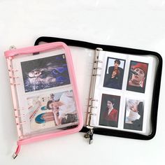 an open binder with photos inside on a white surface