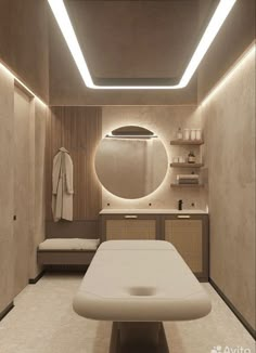 a spa room with a large round mirror