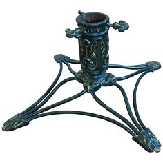 an ornately designed candle holder on a stand