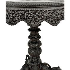 an ornately carved table with marble top