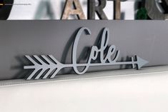 a metal sign that says coffee with an arrow on it and the word art above it