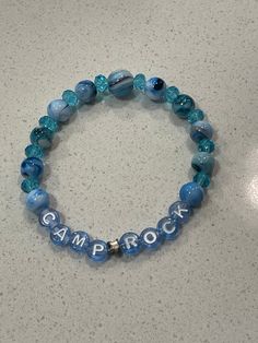 "Handmade Fan Inspired Connect 3/Camp Rock - JoBro Bracelets Unofficial band named beaded stretch bracelet for the \"JoBros\" fans. Meant for inspiring those who love the Bros, this would be the cutest bracelet you could rock representing your favorite brother." Rock Bead Bracelet, Casual Custom Name Beaded Bracelets With Round Beads, Casual Custom Name Beaded Bracelets, Casual Blue Bracelets With Custom Name, Casual Hypoallergenic Name Bracelet With Round Beads, Casual Hypoallergenic Bracelet With Round Beads, Casual Adjustable Name Bracelet, Casual Blue Name Bracelet With Round Beads, Casual Stretch Bracelet With 8mm Beads