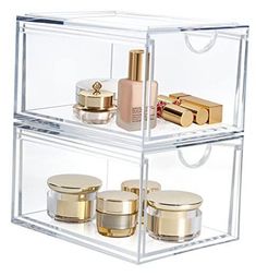 three clear shelves with gold and white containers