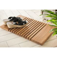 a pair of shoes sitting on top of a wooden mat