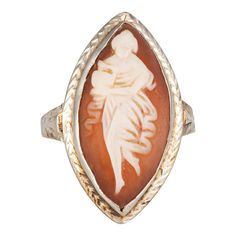 This is part of Chairish’s Fine Jewelry assortment.  Finely detailed vintage Art Deco carved cameo ring (circa 1920s to 1930s) crafted in 14k white gold.   Cameo measures 20mm x 10mm (in good condition and free of cracks or chips).     Carved cameo depicts an elegant woman holding a water vessel in a Grecian style flowing dress. Set into a marquise shaped mount the ring makes a nice statement on the hand. The ring has a low profile and rises 4.5mm from the finger (0.17 inches).    The ring is in Water Vessel, Masonic Jewelry, Russian Jewelry, Bijoux Art Nouveau, Grecian Style, Antique Jewelry Rings, Vintage Cocktail Ring, Flowing Dress, Gold Cocktail Ring